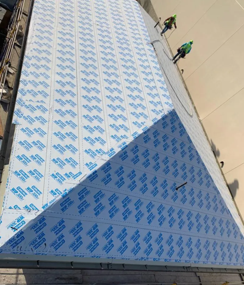 Professional roofers installing underlayment on a metal roof in Santa Monica